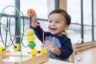 Child playing with a puzzle toy