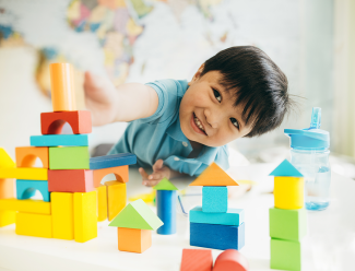 Child playing with a set of colorful blocks