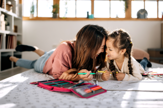 mother and daughter bonding while coloring a book